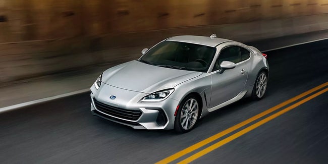 Silver 2023 Subaru BRZ driving on a mountain road