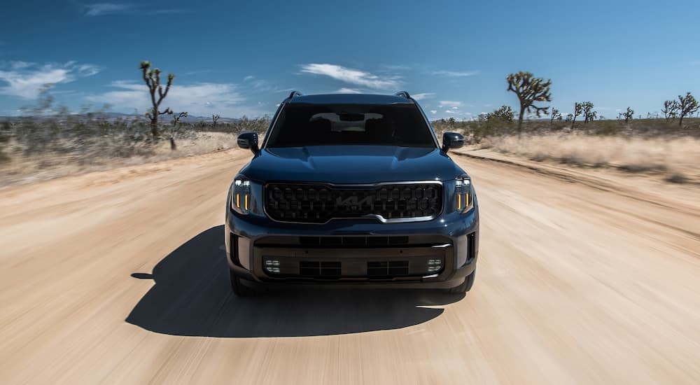 Black 2025 Kia Telluride driving on a trail