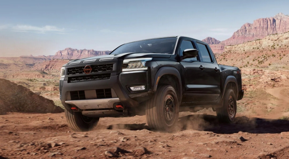 Black 2025 Nissan Frontier PRO-4X driving off-road