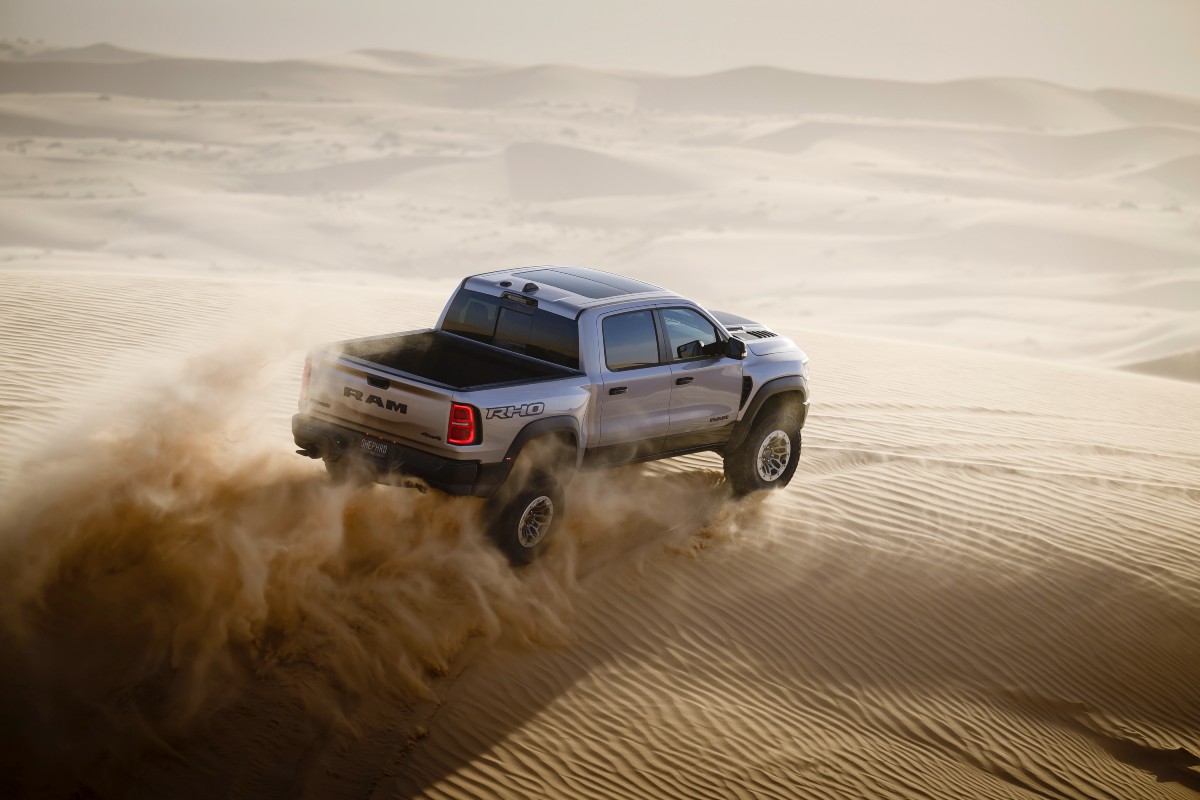 2025 RAM 1500 RHO Exterior Passenger Side Rear Profile on Sand Dunes