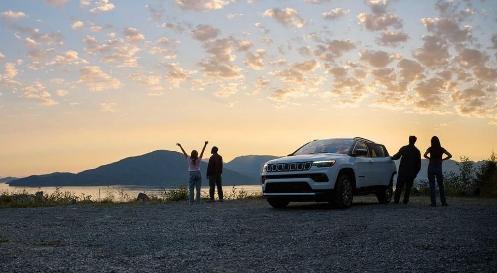 White 2024 Jeep Compass for sale parked near a lake