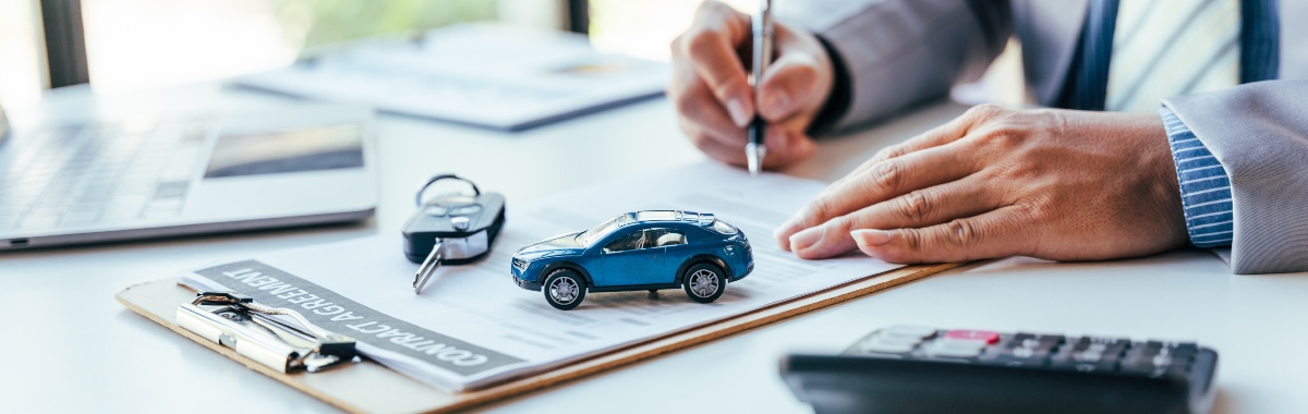 Man Signing Car Insurance Document