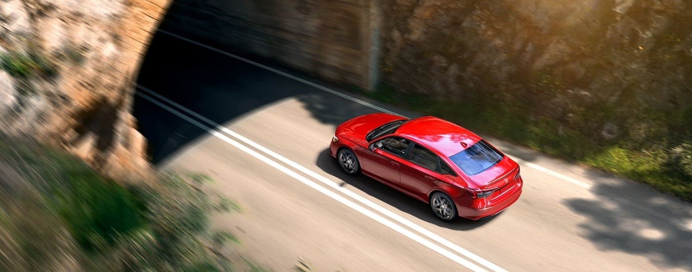 Red 2022 Honda Civic Sport driving into a tunnel