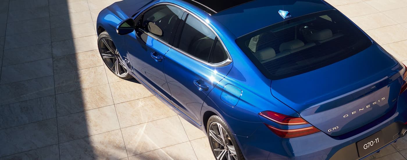 A blue 2026 Genesis G70 parked in a showroom