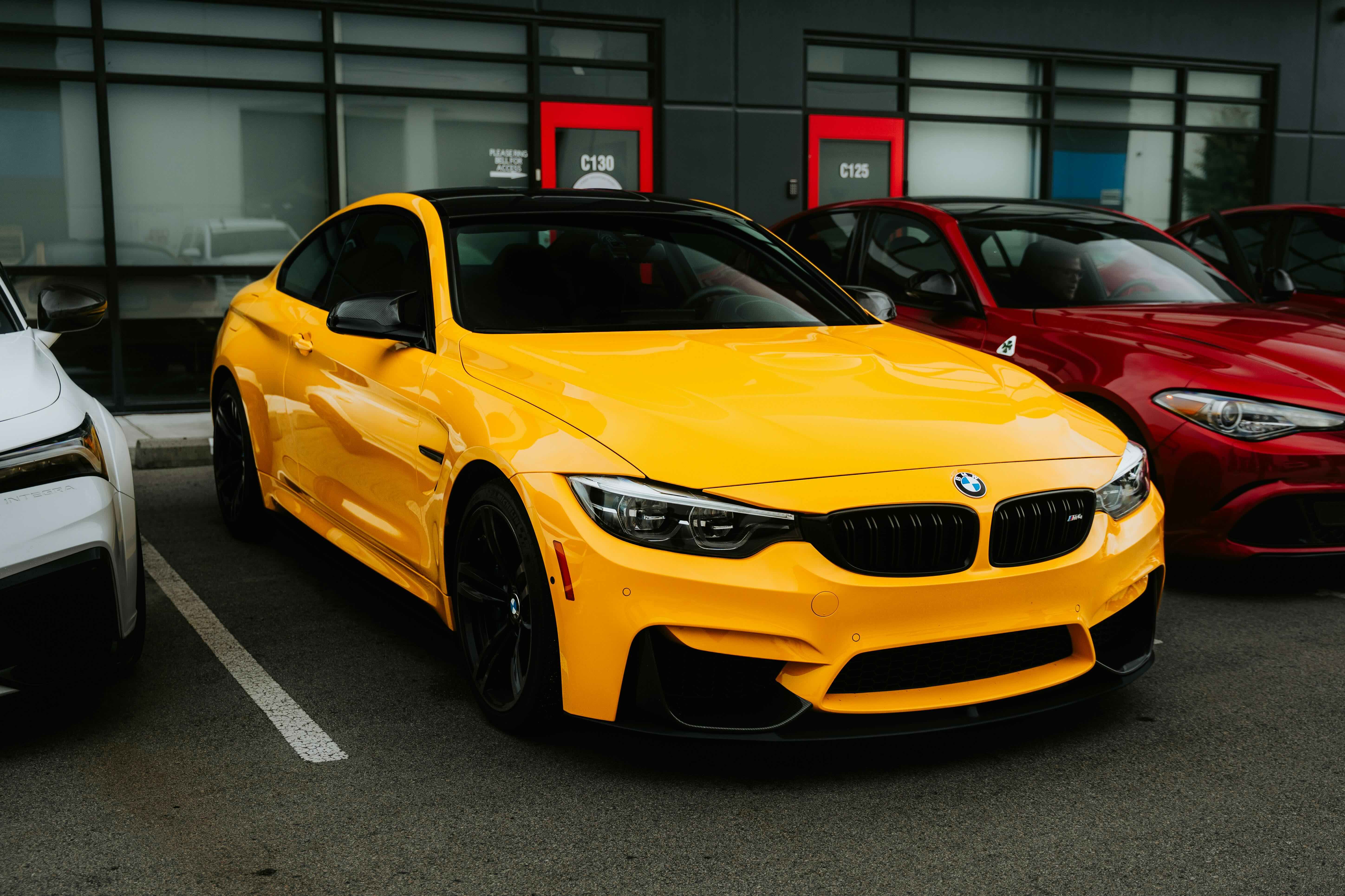 Yellow BMW in a parking lot