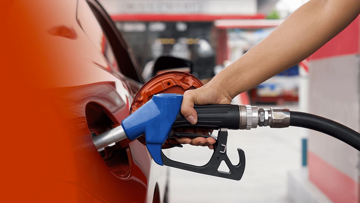 gas being pumped in an orange car