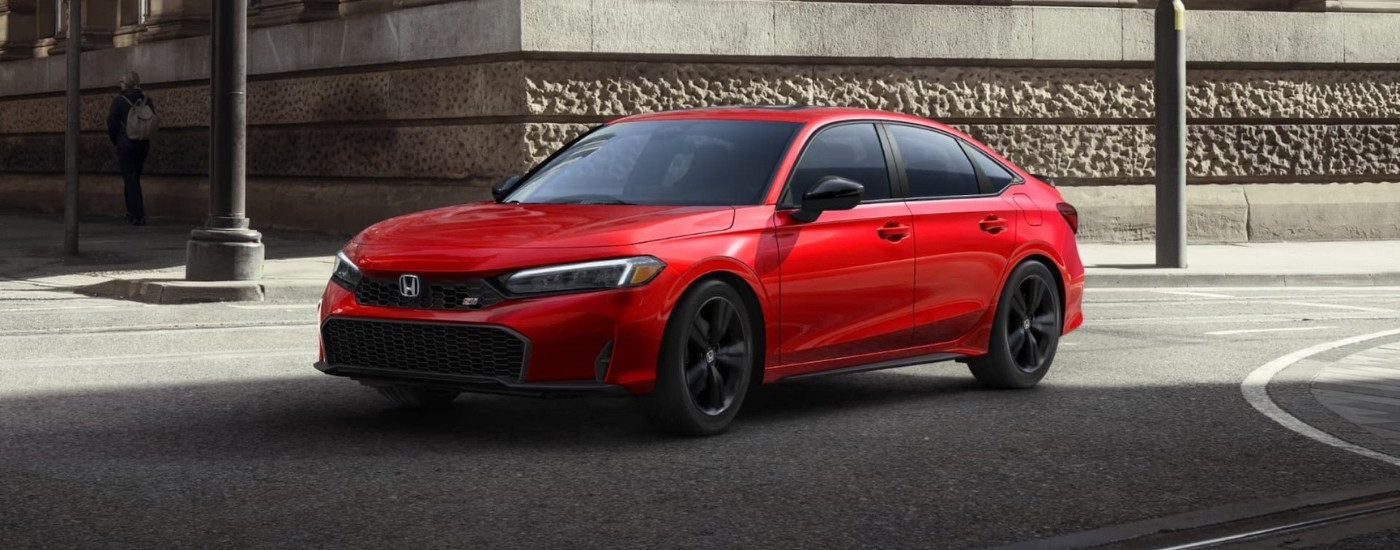 Red 2025 Honda Civic Si driving to a Honda dealer