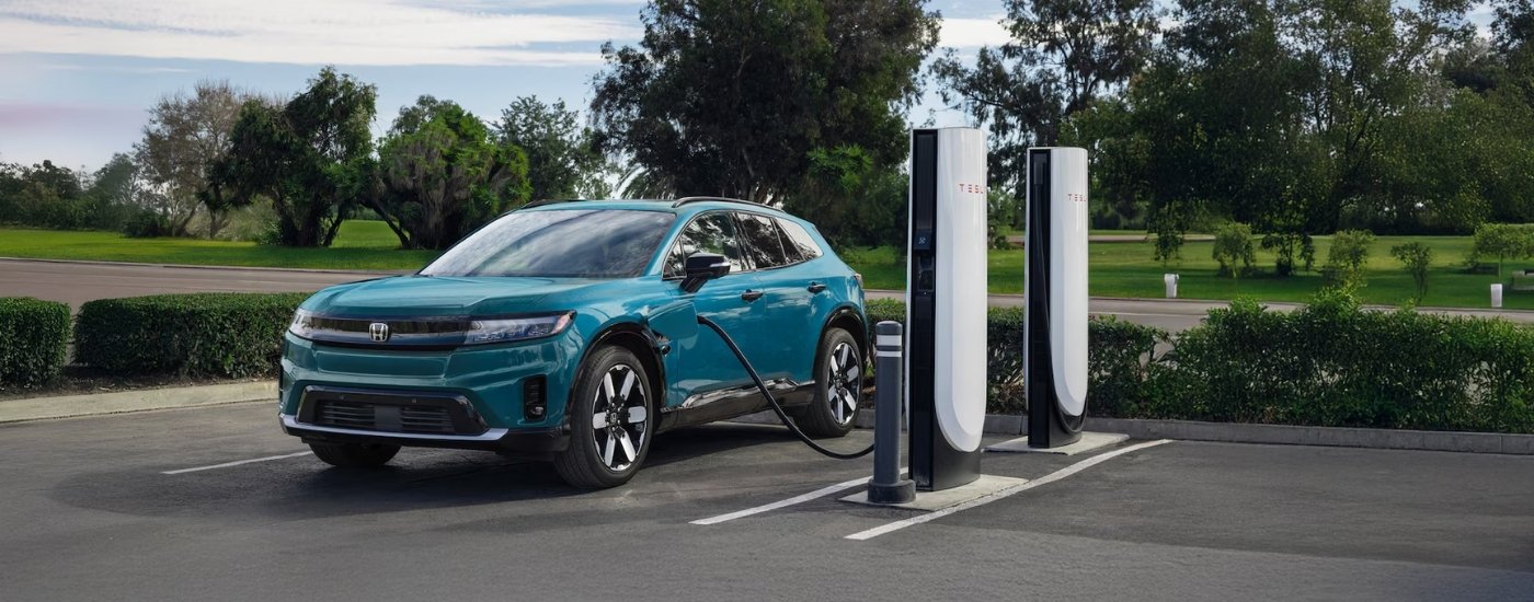 Teal 2025 Honda Prologue at a charging station