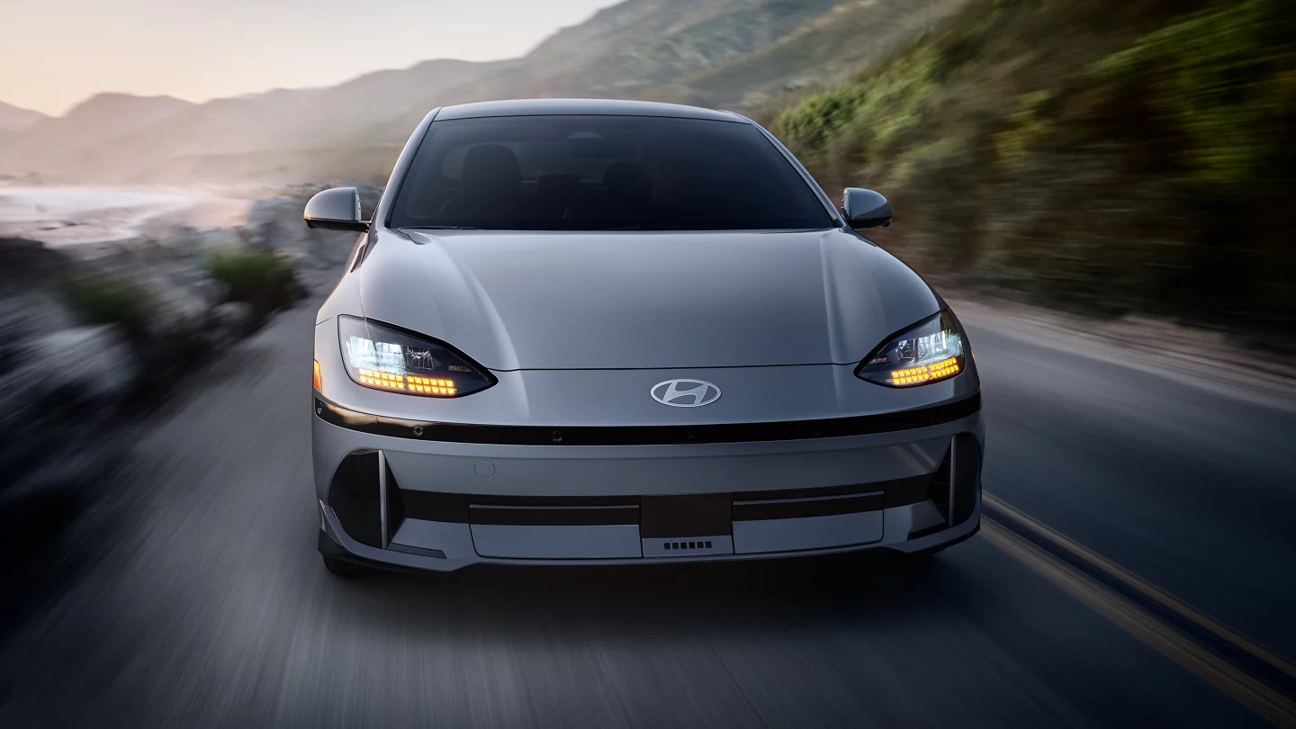 A Hyundai IONIQ 6 driving on a road.