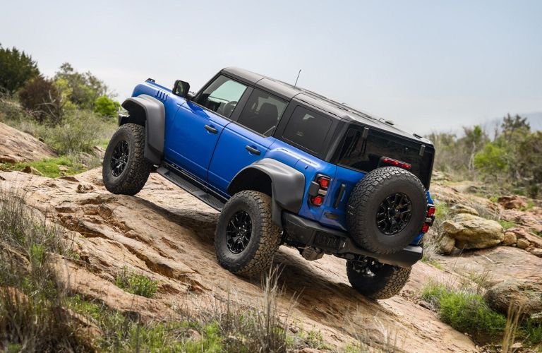 Blue 2025 Ford Bronco Rear Exterior with Black Appearance Package on Rocky Trail