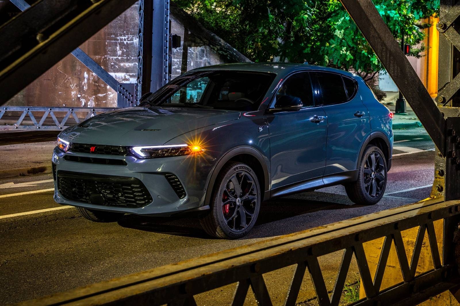 A blue suv sitting in the road.