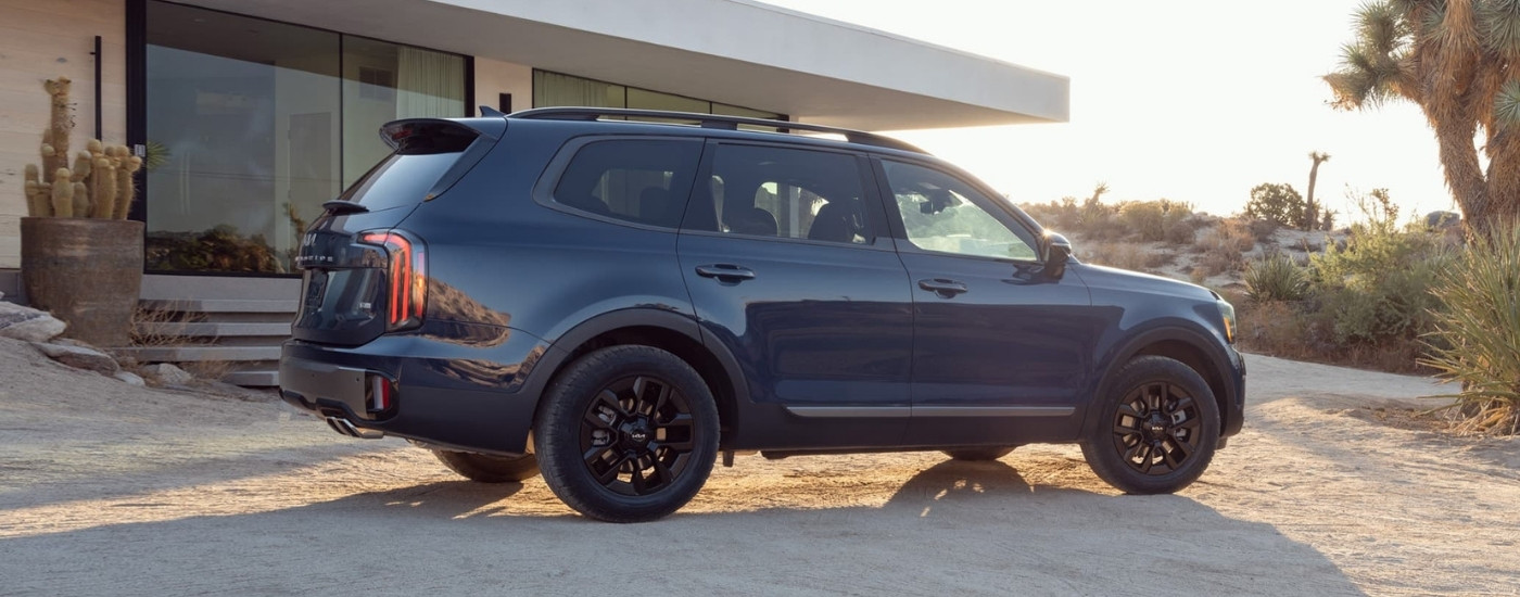 Blue 2025 Kia Telluride parked on a dirt driveway