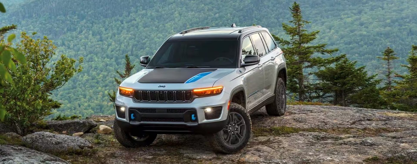 A white 2024 Jeep Grand Cherokee from the front.