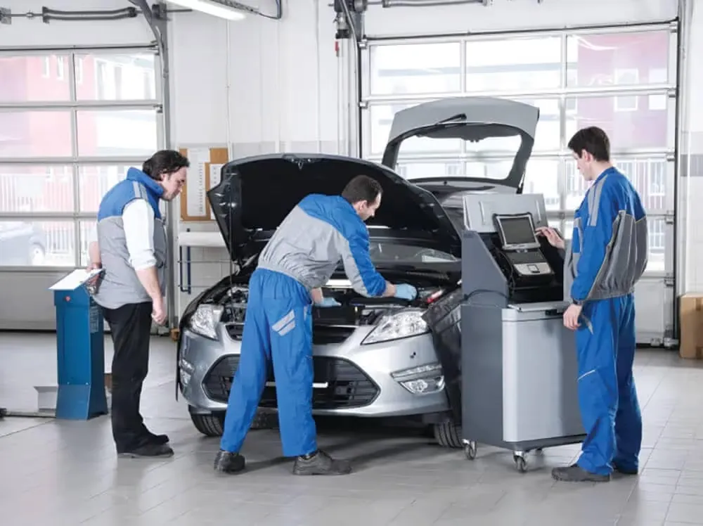 Mechanics servicing a car