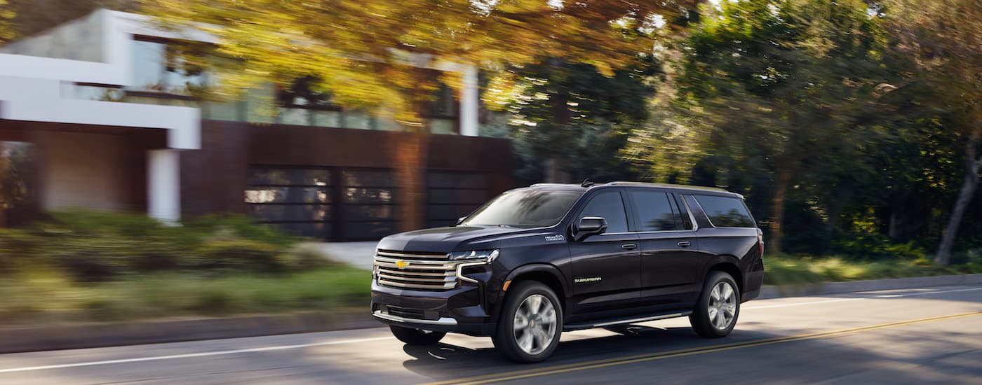 A black 2022 Chevy Suburban is shown from the side after leaving a dealer that has used cars for sale near Fruitland.