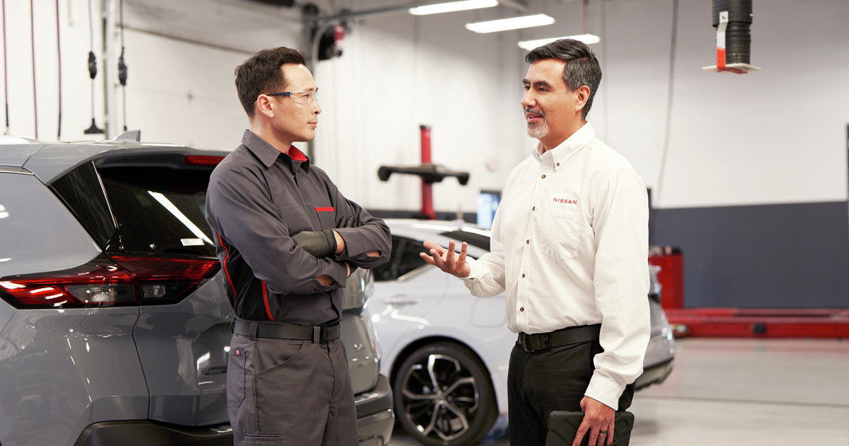 Nissan service advisor speaking to a Nissan service technician