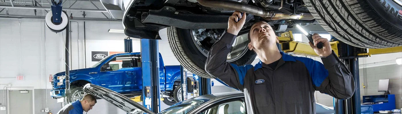 image of ford employee working on underside of vehicle