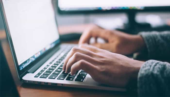 Hands typing on a laptop in the service lounge