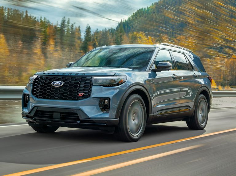 New 2025 Ford Explorer ST model driving along a hilly highway landscape