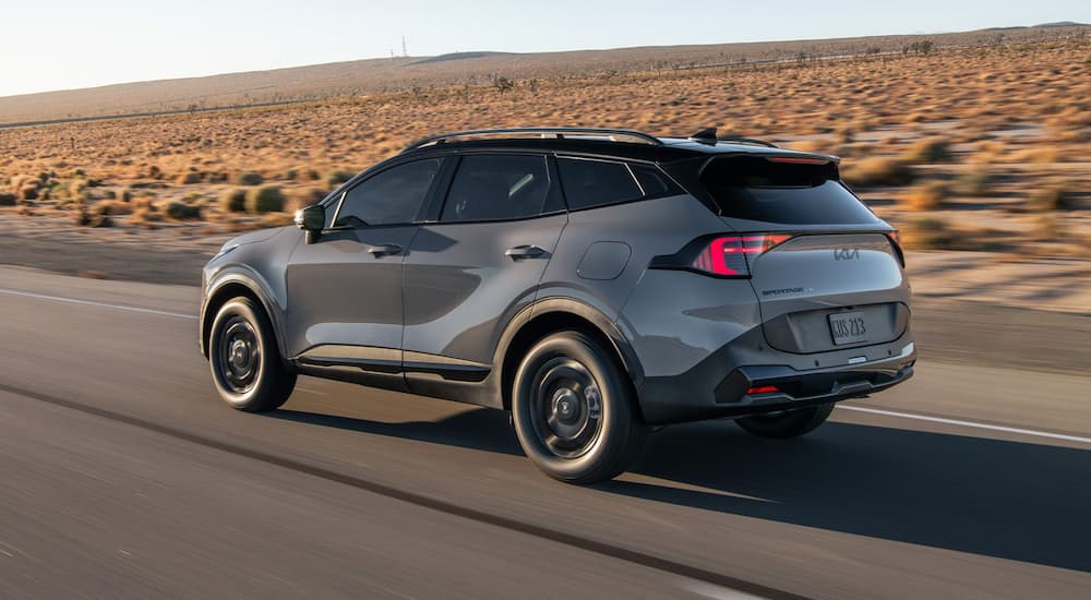 Gray 2026 Kia Sportage driving on a highway