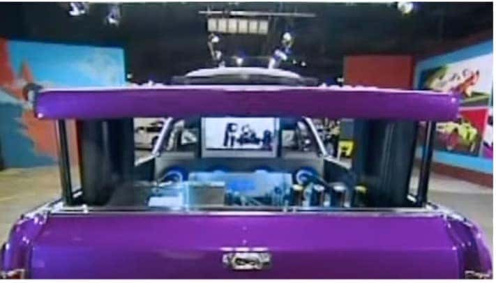 Purple car trunk fitted with custom screens and audio