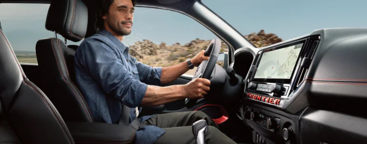 Person driving in a 2025 Nissan Frontier