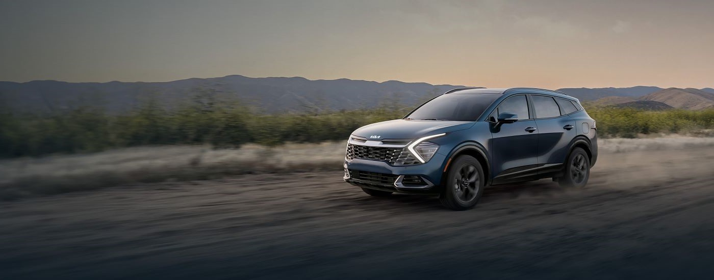 Blue 2025 Kia Sportage for sale near Waukesha driving off-road