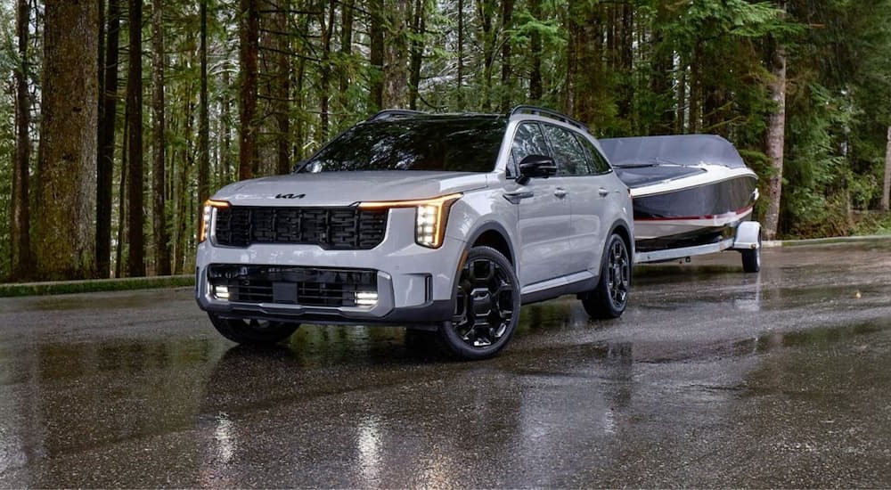 Grey 2025 Kia Sorento for sale is towing a boat