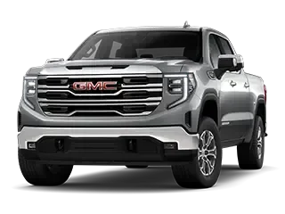 Front three-quarter studio view of a silver GMC pickup truck with a legible GMC grille badge and chrome trim, on a white background