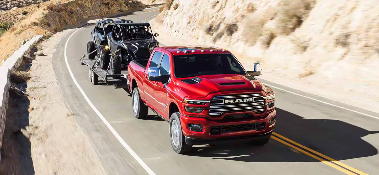 A red truck pulling a trailer.