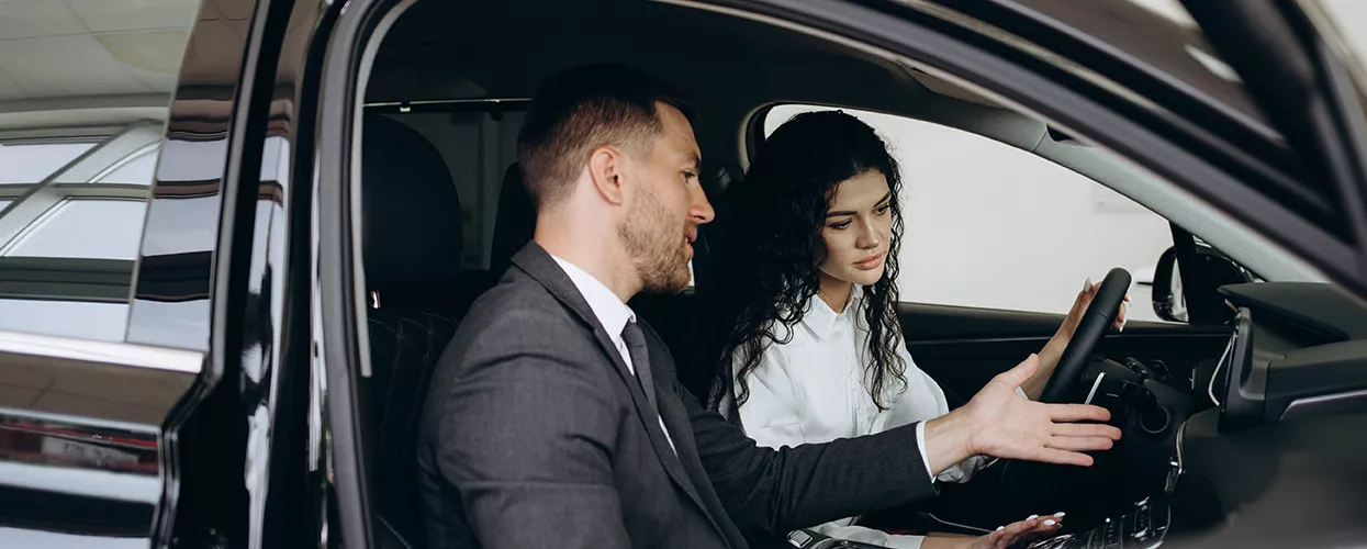 agent showing car features to customer