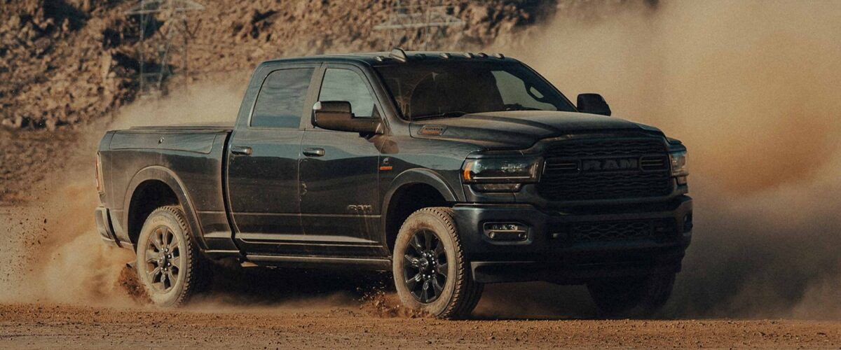 A black 2022 RAM 2500 driving through the dirt.