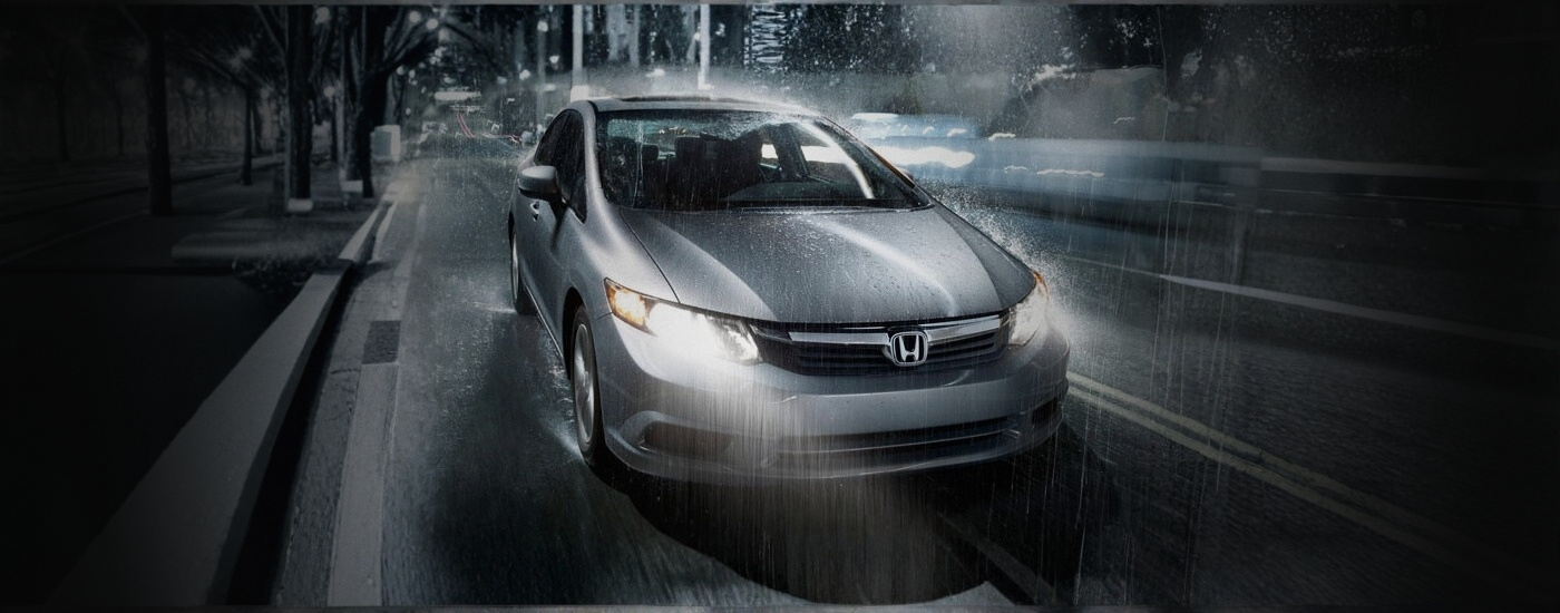 Silver 2012 Honda Civic on a rainy night