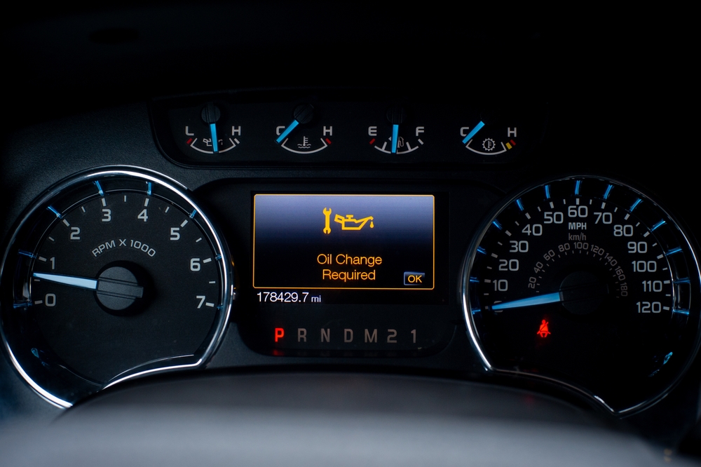 Dashboard displaying an 'Oil Change Required' warning light.