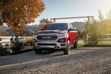 Red Ram 1500 parked on gravel with autumn trees behind