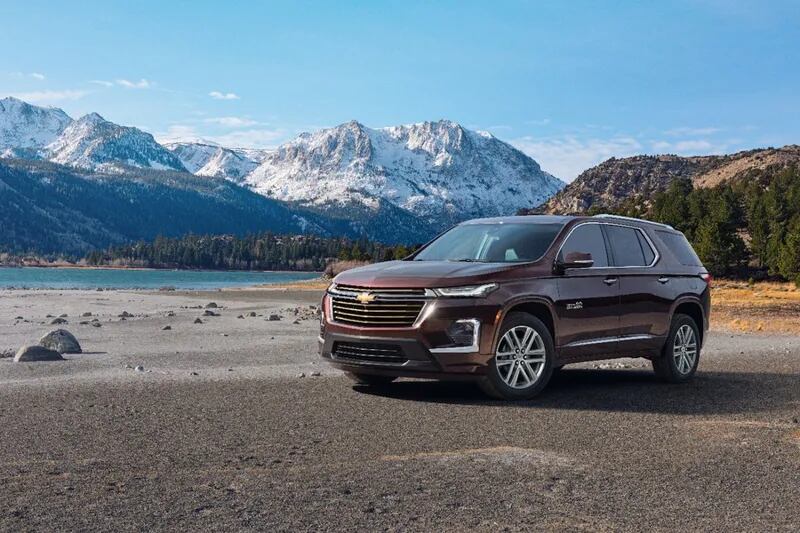a red suv parked in a mountain valley