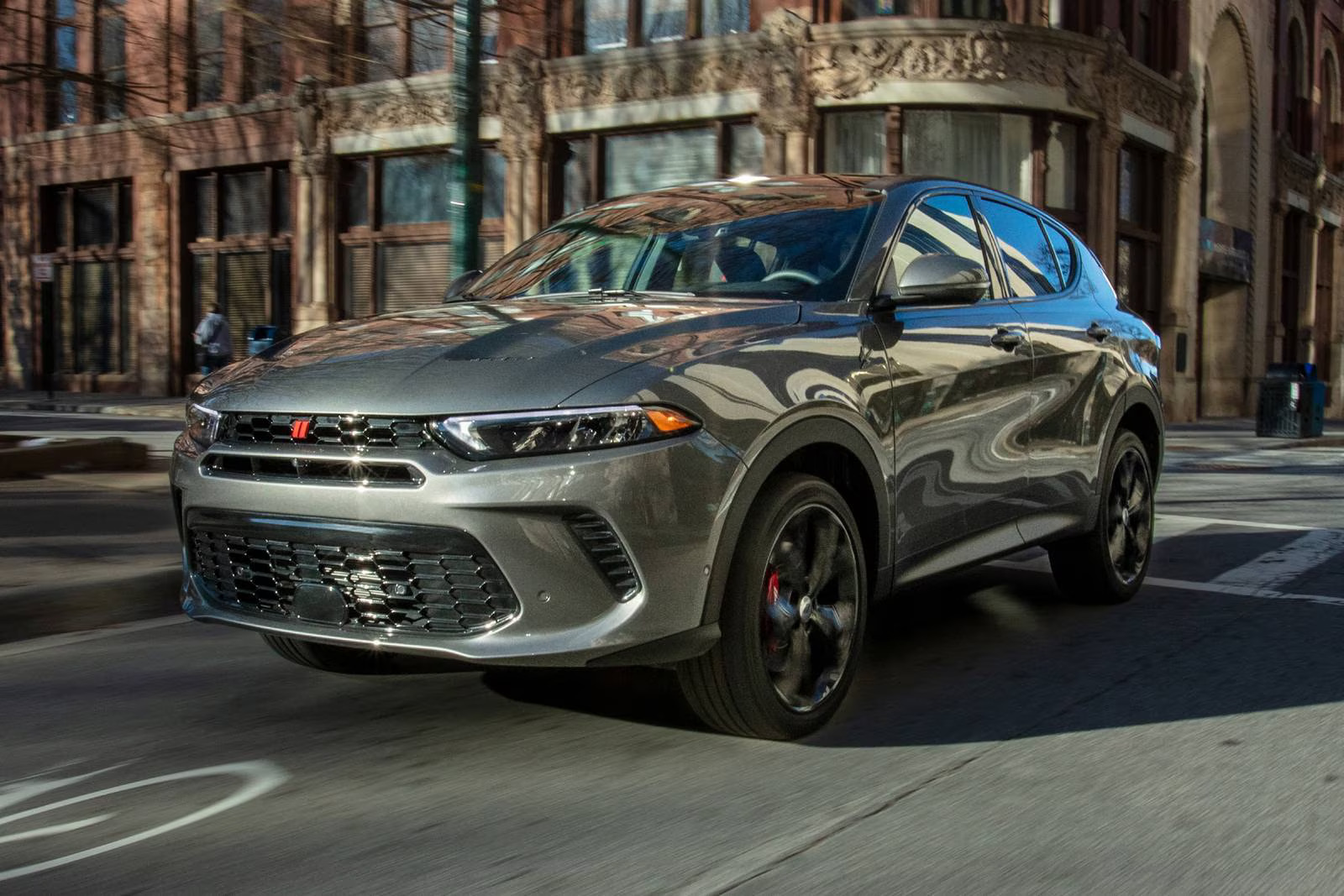 A gray suv driving on the road.