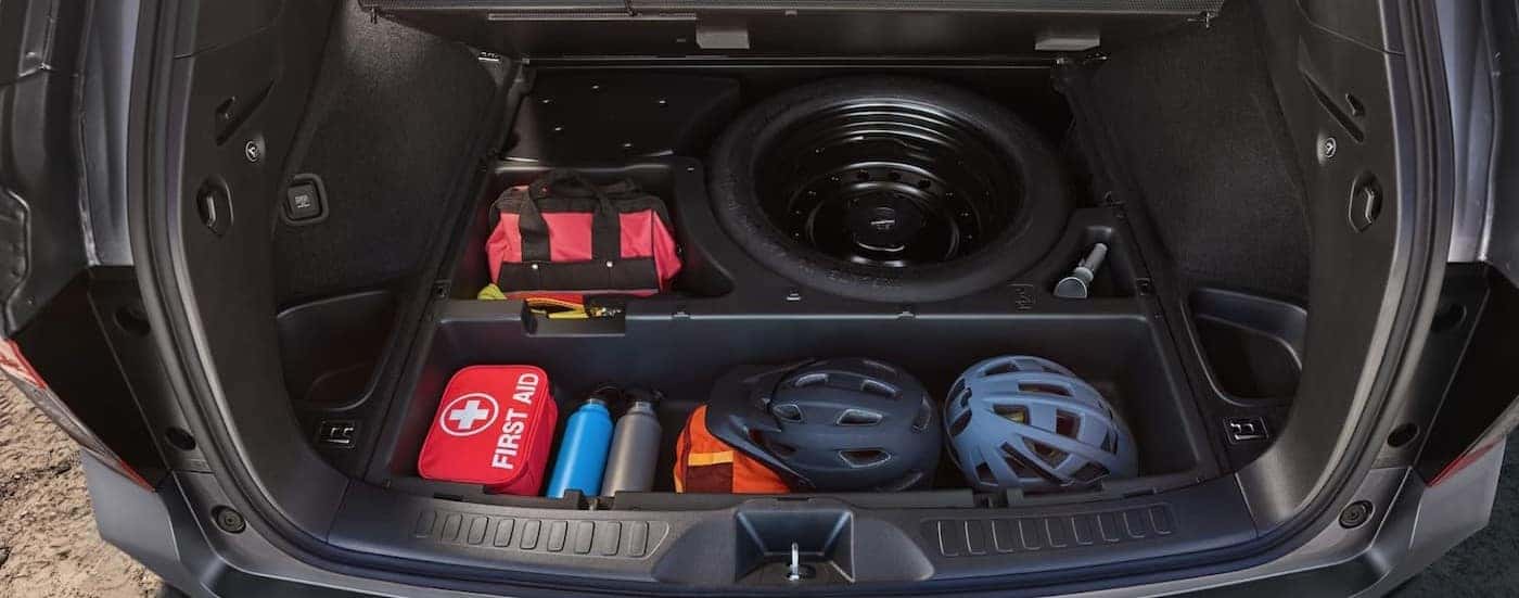 Underfloor storage is shown in the cargo area of a silver 2025 Honda Passport TrailSport.