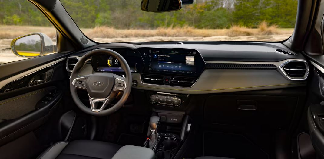 Interior view of the 2024 Chevrolet Trailblazer's front cabin, featuring a modern dashboard, advanced infotainment system, and comfortable seating.