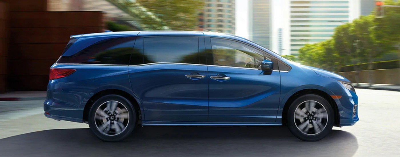 Blue 2020 Honda Odyssey driving through a city