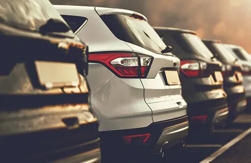 Row of new SUVs lined up on the dealership lot