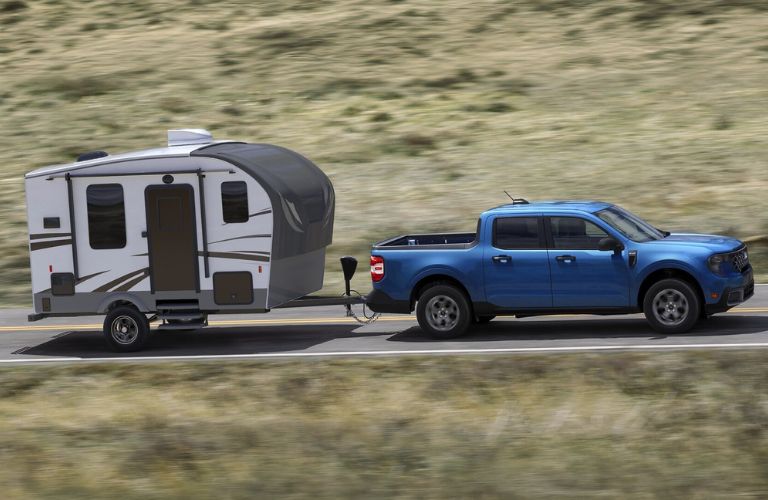 Blue 2025 Ford Maverick Towing a Teardrop Camping Trailer
