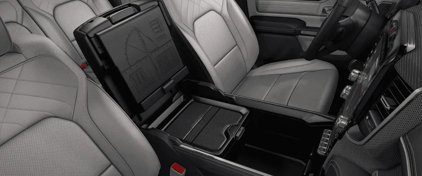 Ram 1500 interior with leather seats, storage compartment, and large touchscreen