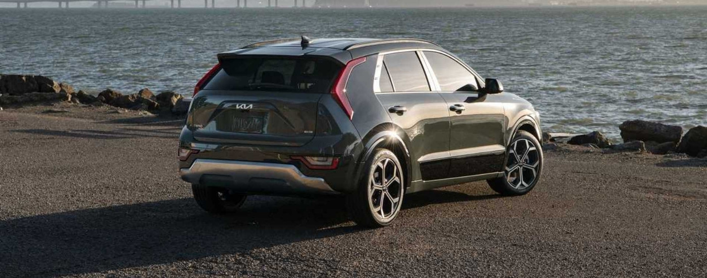 Green 2025 Kia Niro Hybrid is overlooking a river