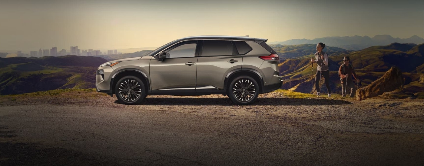 People hiking near a 2023 Nissan Rogue