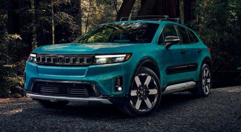 A blue 2026 Honda Prologue parked on gravel