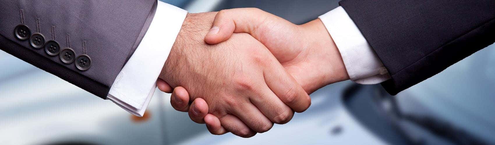 Handshake over a car purchase at BMW dealership