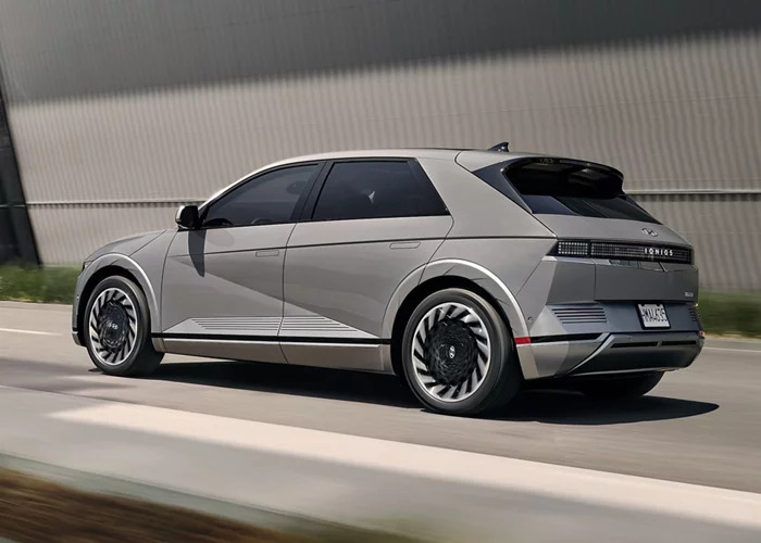 A 2024 Hyundai IONIQ 5 driving on a road.