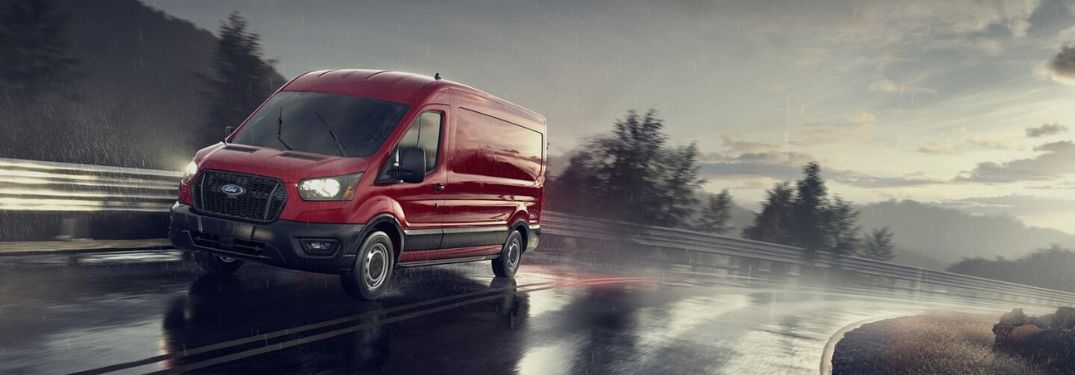 Red 2024 Ford Transit Driving on a Highway in the Rain