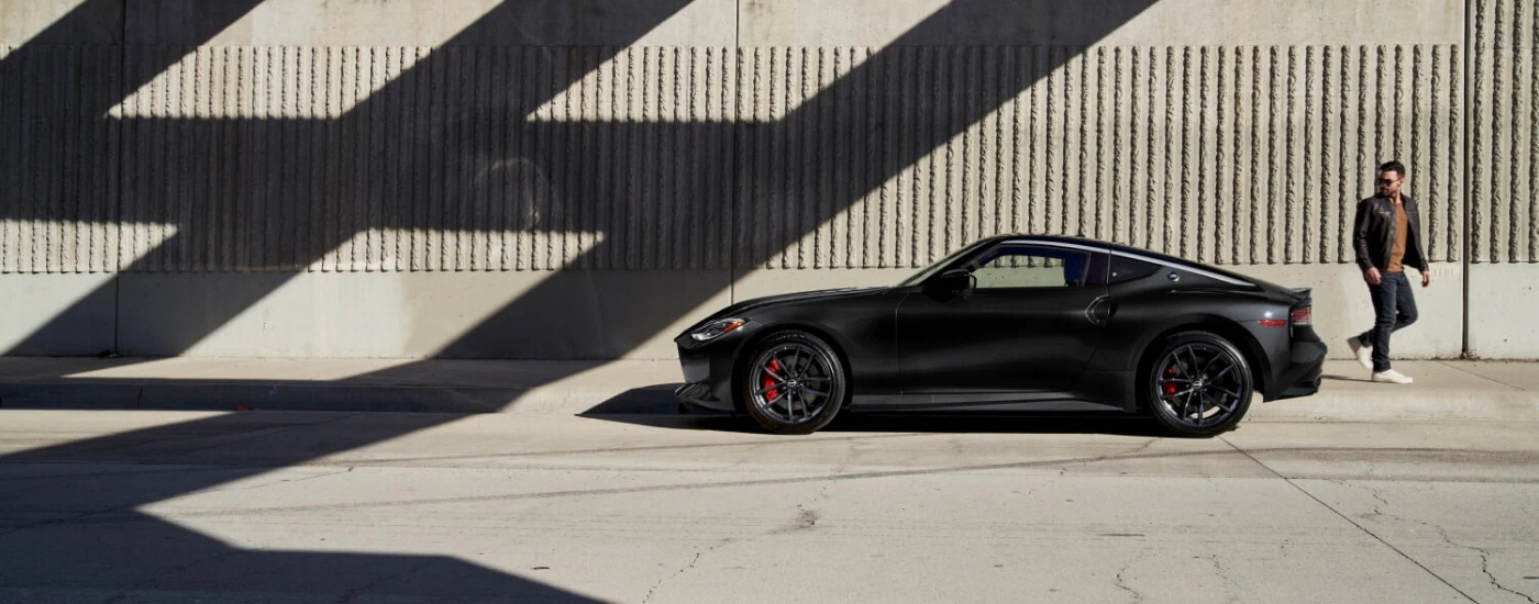 Person looking at a black 2026 Nissan Z